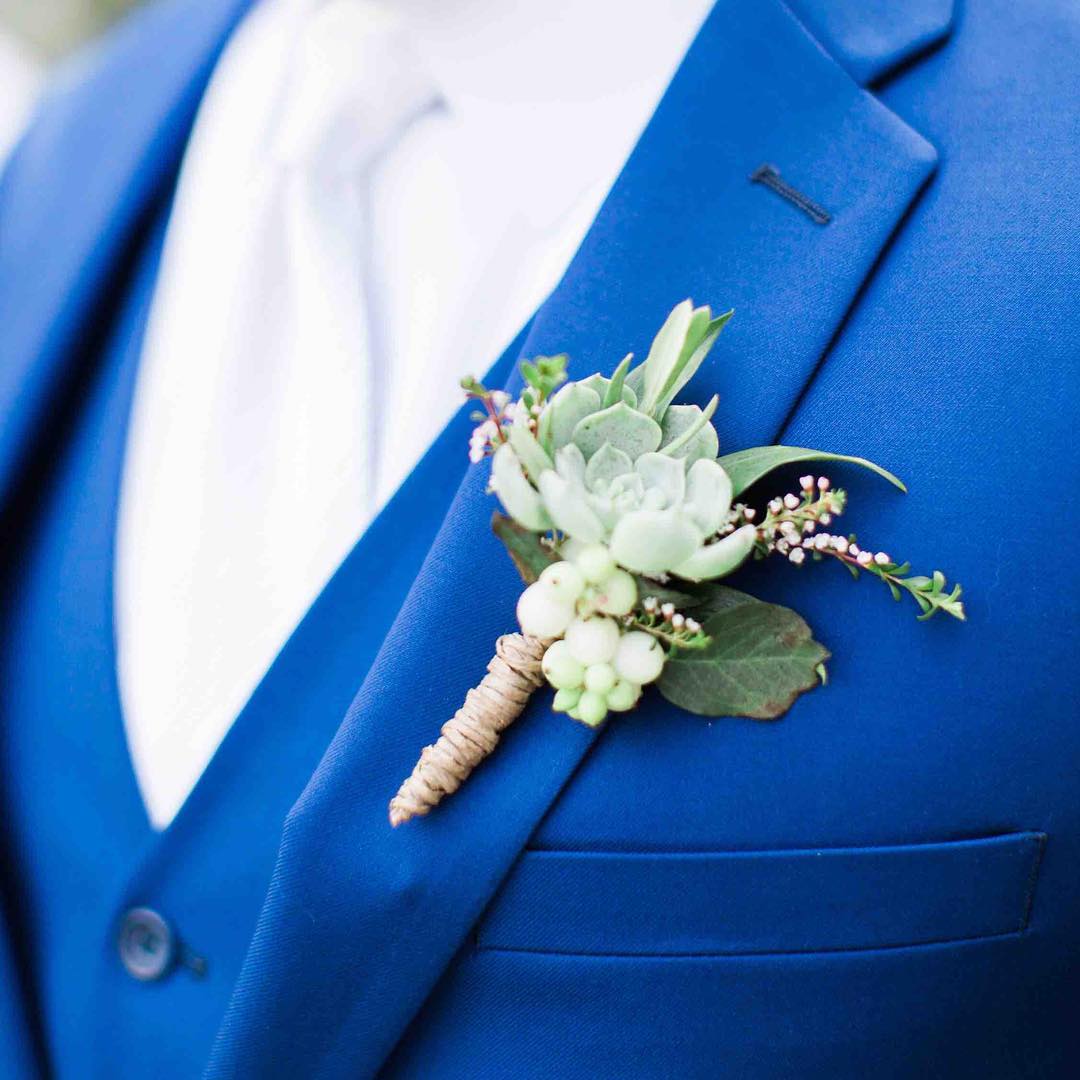 {man-decor}
photo | @jharperphoto .
.
.
#manflowers #boutonniere #forhim #manbling #succulents #snowberries #groom #alldressedup #weddingattire 
#lotusfloraldesigns #weddingflowers